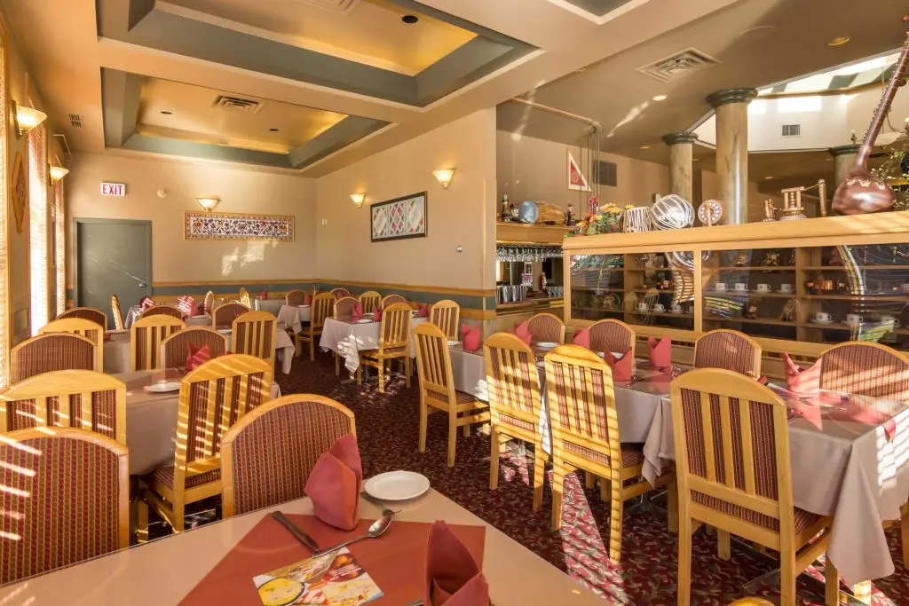 Main dining room with set tables at Namskar